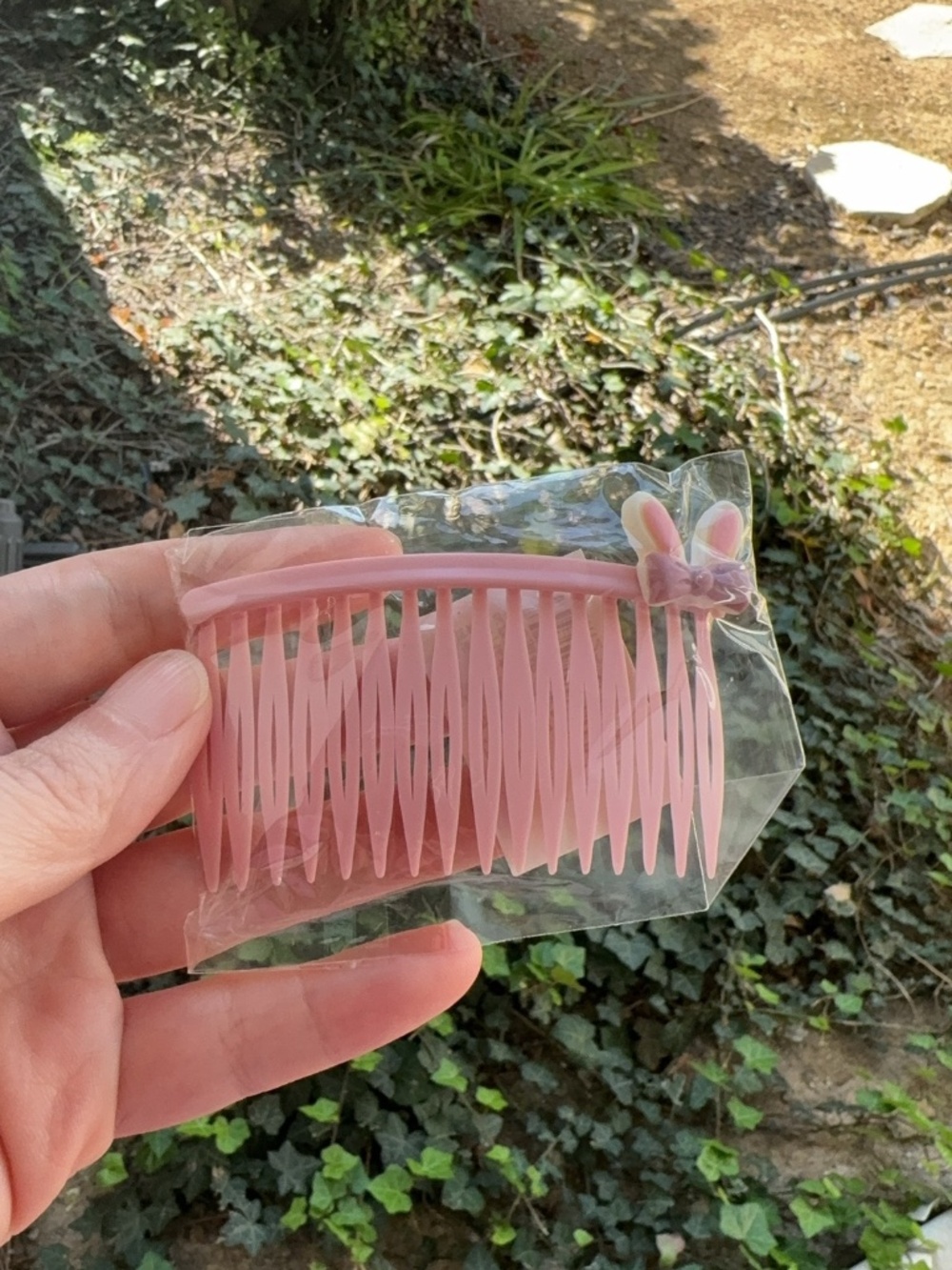 pink translucent plastic hair combs featuring a small bow